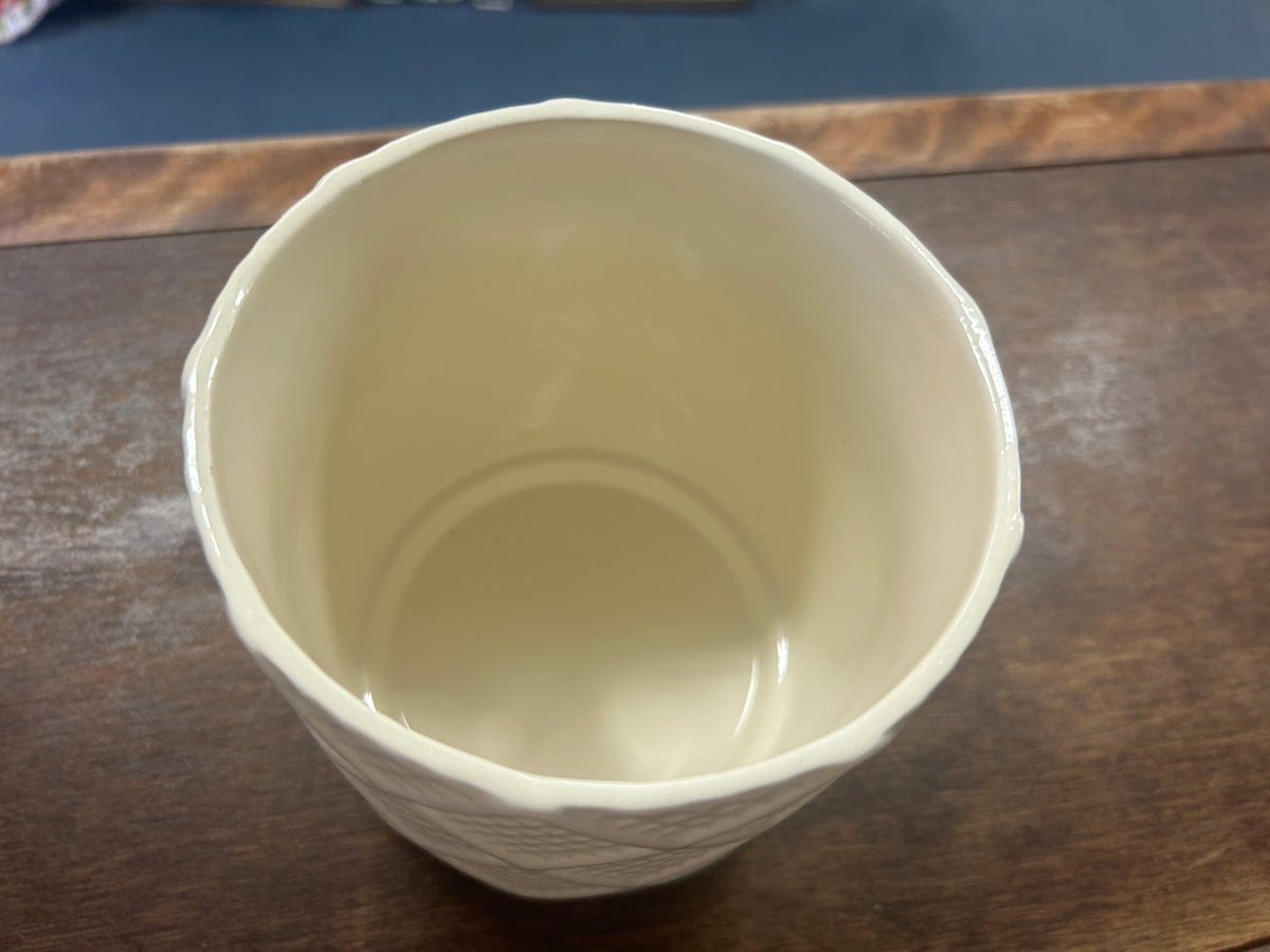 Cream planter pot viewed from above, showing its smooth interior.