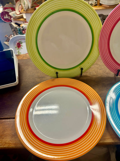 Orange striped melamine plate with a white center and red inner ring.