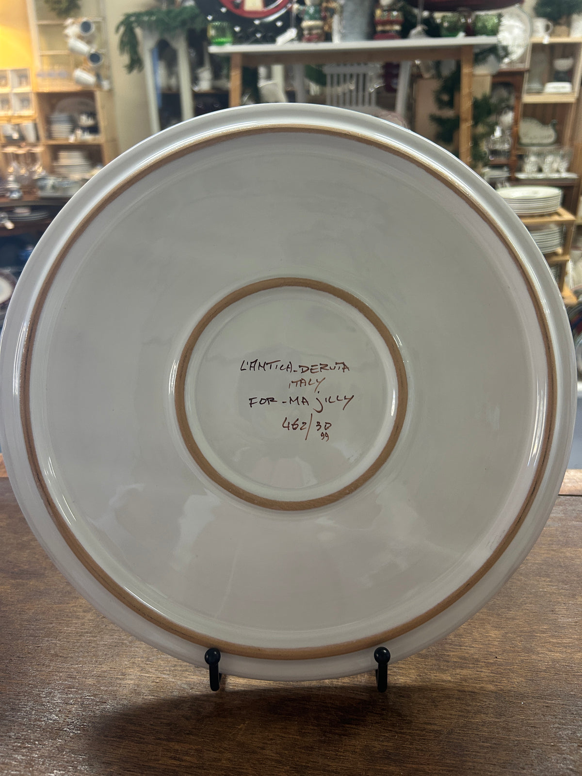 Back of footed platter with maker's mark and raised circular rings