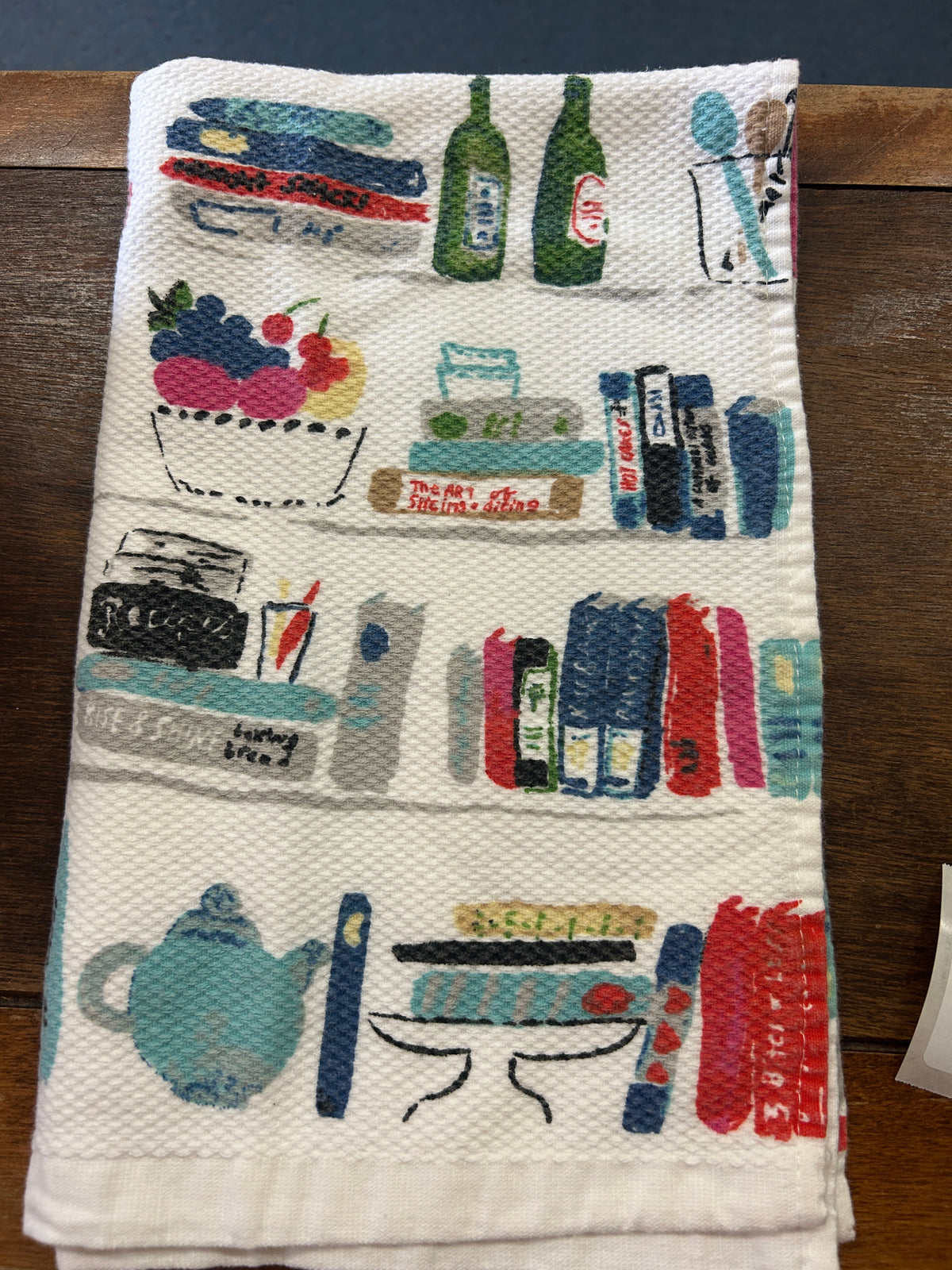 Reverse side of the Kate Spade dish towel with colorful kitchen illustrations and a textured weave.