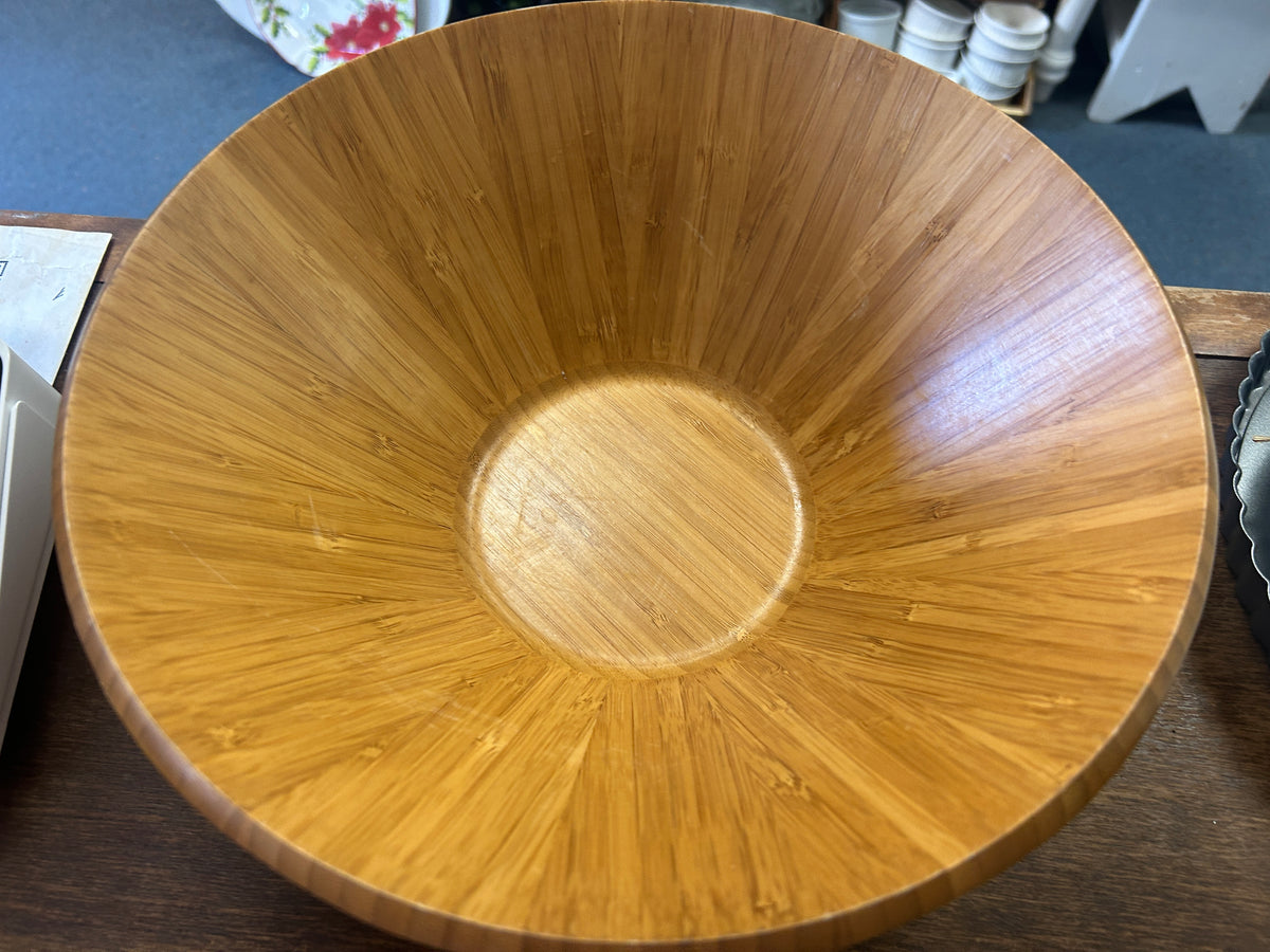 Round wooden salad bowl with visible grain radiating from the center