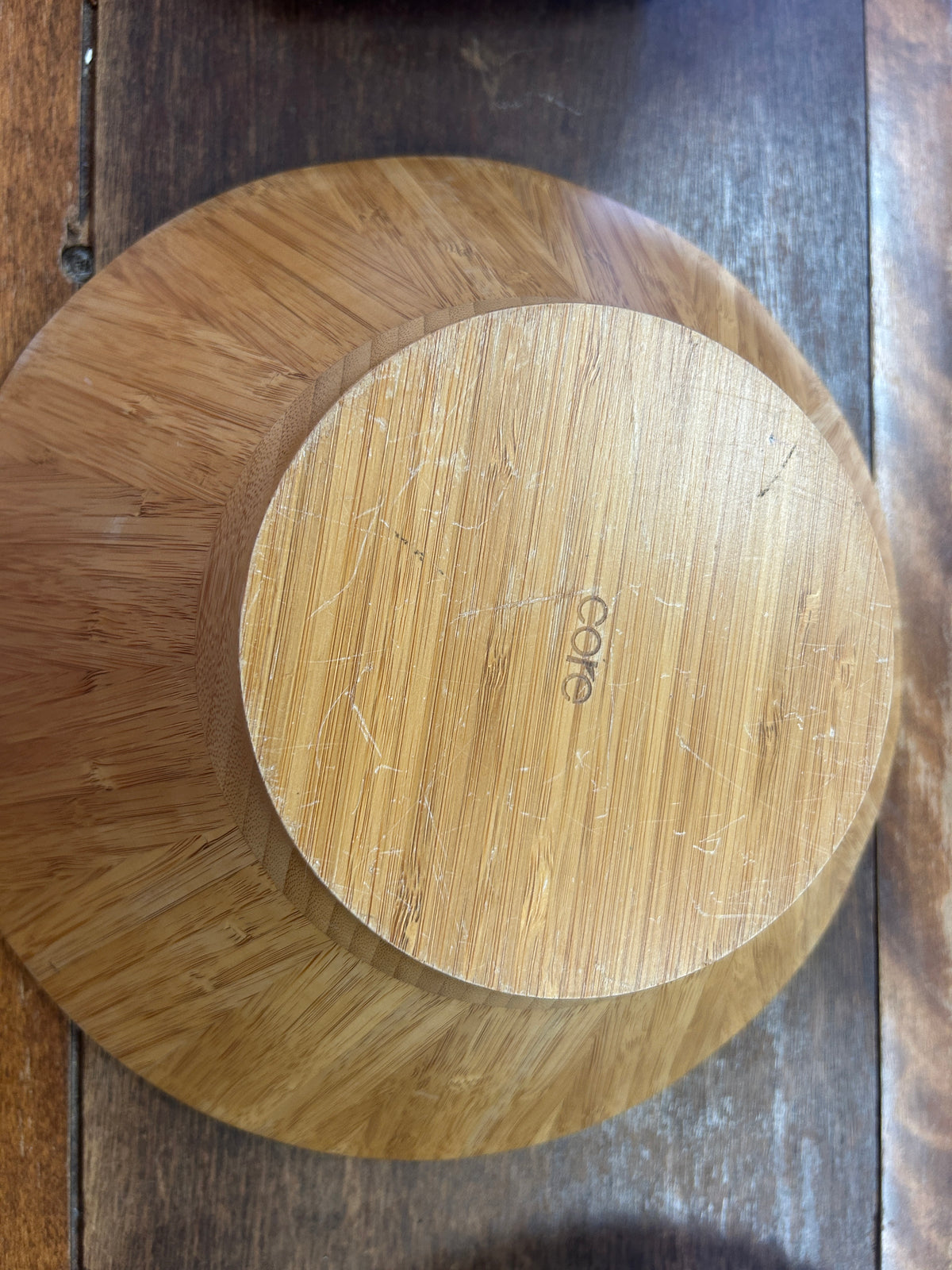 Wooden bowl underside with a raised circular base and Core mark