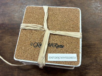 Square coaster underside with cork backing and a food-contact warning label