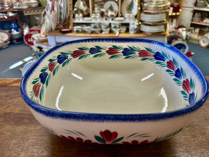 Quimper ceramic serving bowl with floral border and blue rim, shown from above