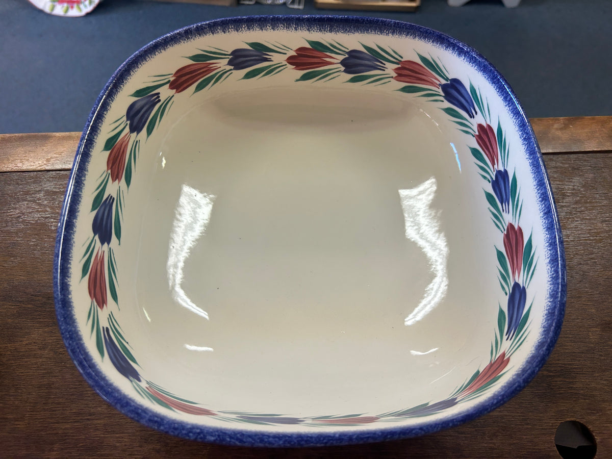 Square serving bowl with painted floral border and blue rim, viewed from above
