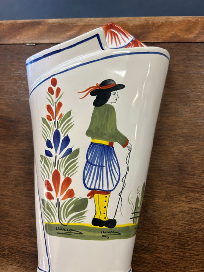 Quimper ceramic wall vase painted with a figure in a green top and blue skirt