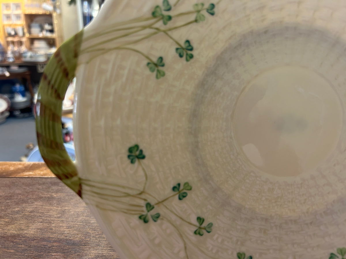 Close-up of the platter's green shamrock vines and textured cream surface