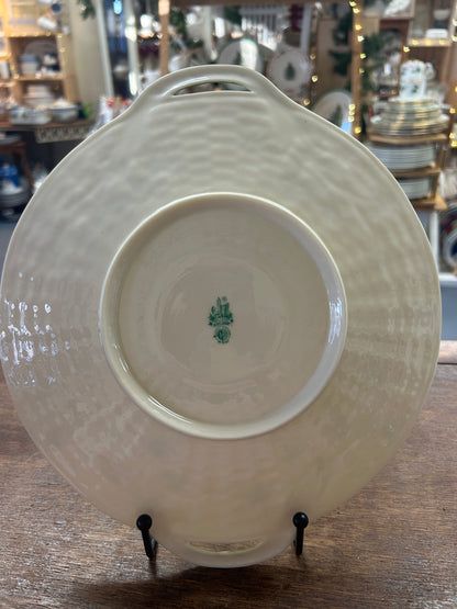 Back of the cream platter with raised foot ring, maker's mark, and handle