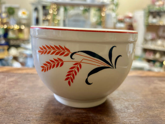 Vintage white ceramic bowl with orange leaf and cattail pattern, red rim