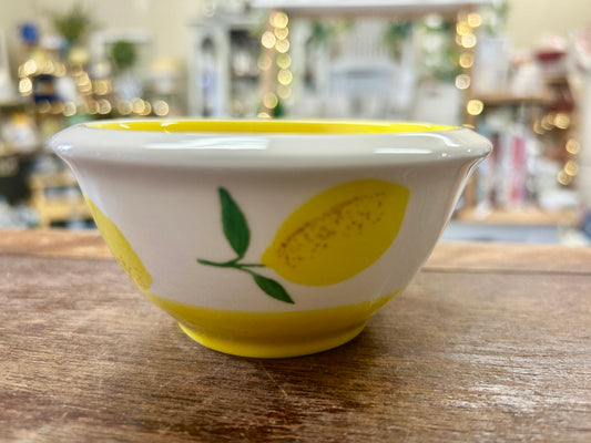 Ceramic lemon bowl with white rim and yellow lemon print, green leaves.
