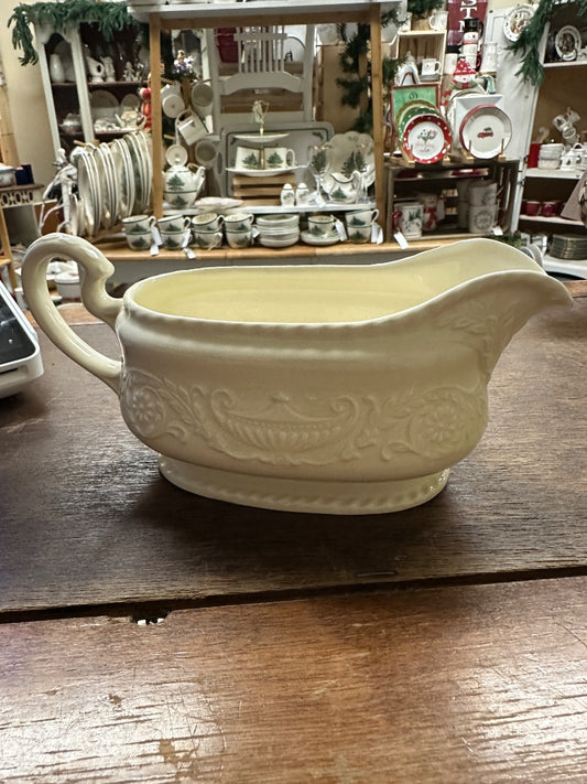 Ivory Steubenville antique gravy boat with molded floral scroll design and curved handle