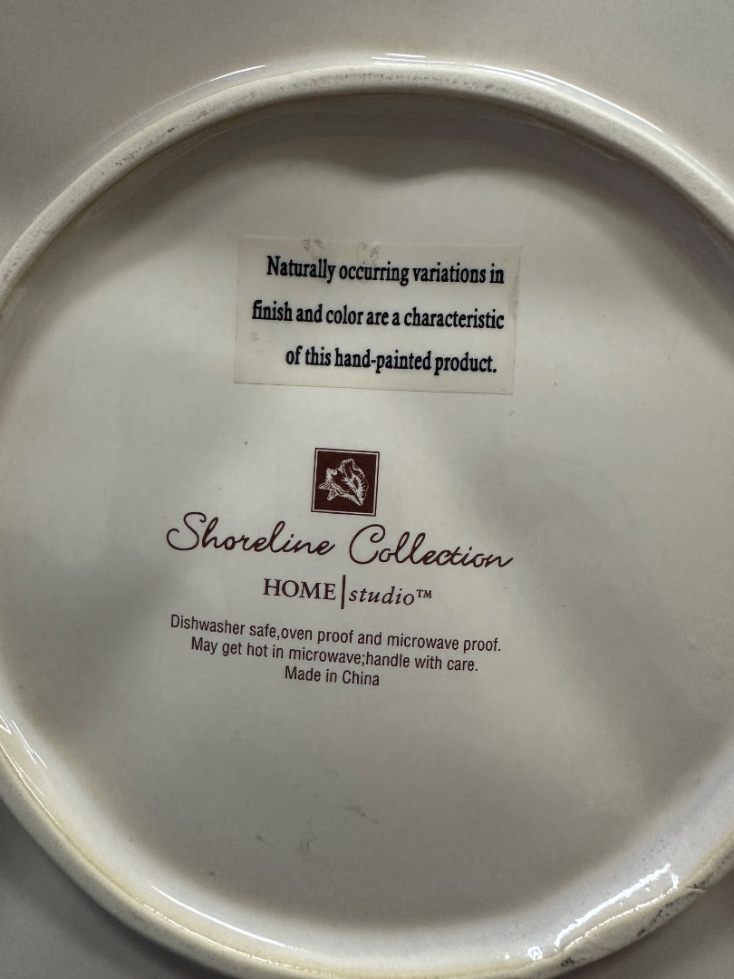 Starfish platter underside with Shoreline Collection Home Studio branding and care text
