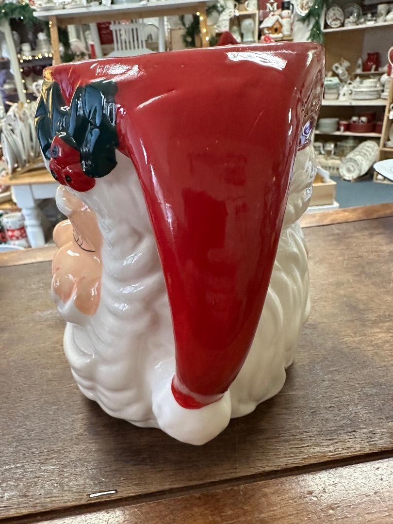 Red and white Santa face utensil crock, three-quarter side view with handle