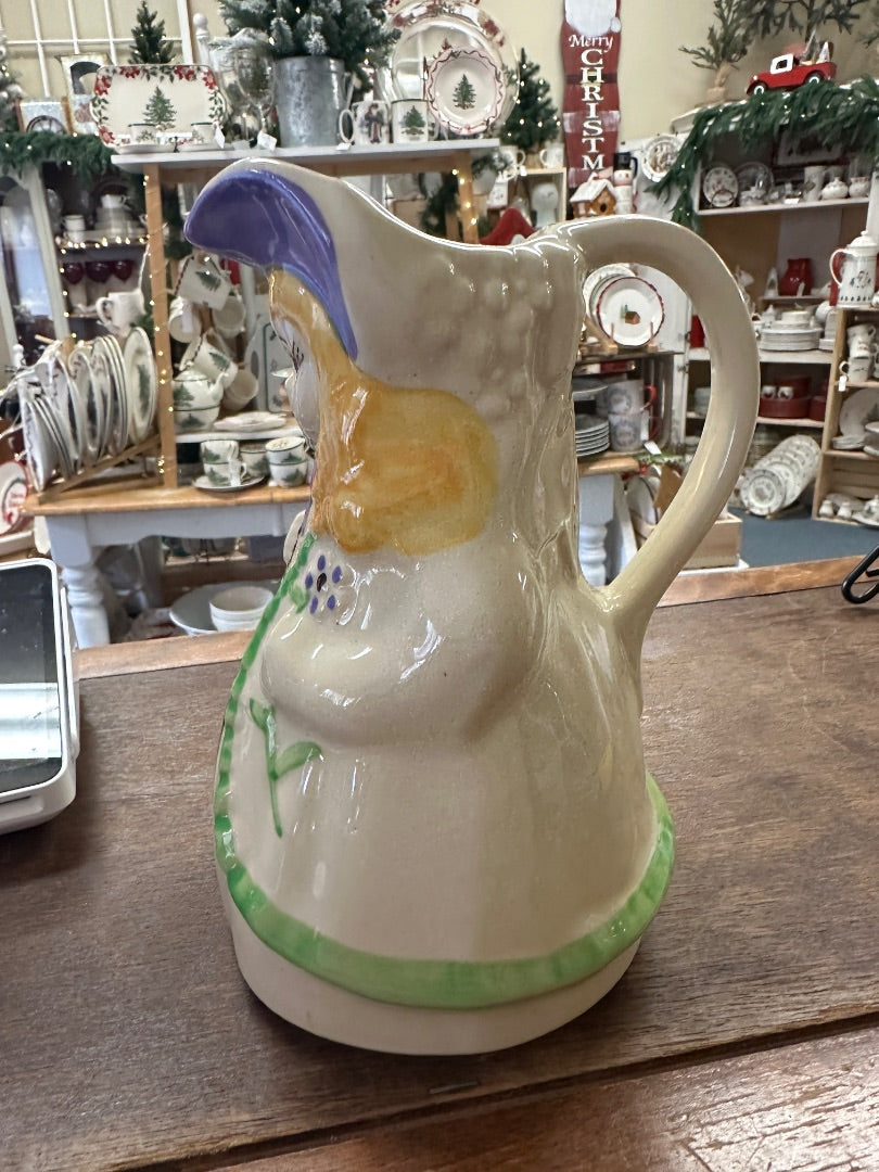 Ceramic pitcher with side spout and handle, purple bonnet artwork, green banded base