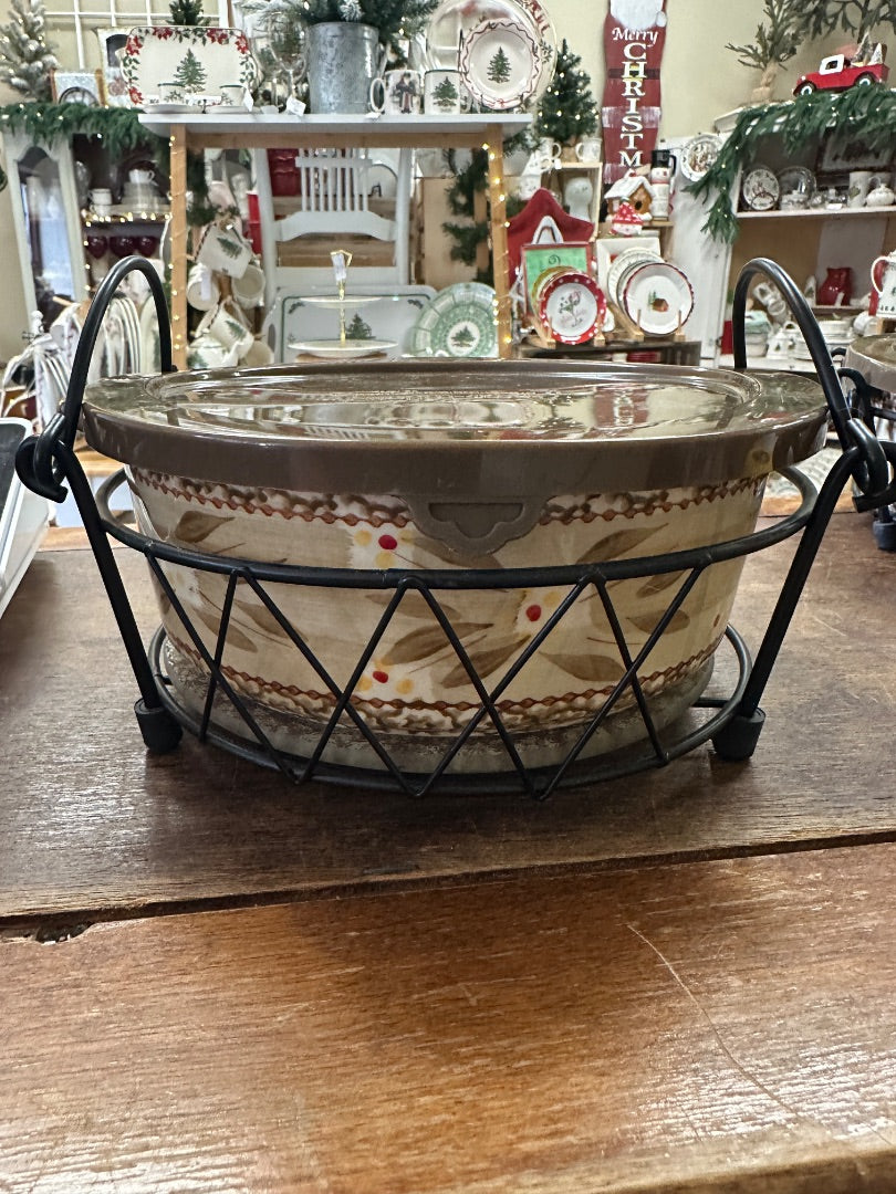 Ceramic baker with lid on black wire rack, beige with brown speckled floral pattern