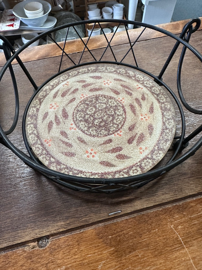 Lidded ceramic baker in black wire rack, beige top with brown speckled center