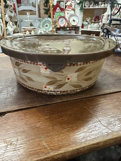 Lidded ceramic baker with loop handles, beige with brown and tan floral accents