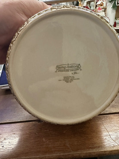 Bottom of cream ceramic baker with temp-tations stamp on beige glazed base