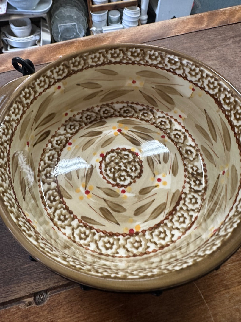 Brown patterned ceramic baking dish interior with ornate medallion
