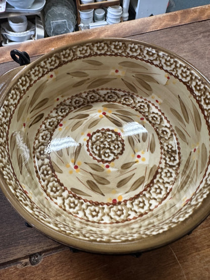 Brown patterned ceramic baking dish interior with ornate medallion