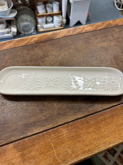 White oval holiday tray with embossed pine trees and snowflake relief pattern