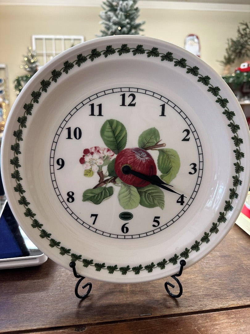 White porcelain wall clock with green leaf border, apple illustration, and black hour numbers