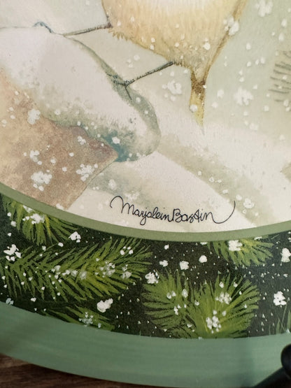 Decorative plate detail: Marjolein Bastin script on snowy bird artwork with green border