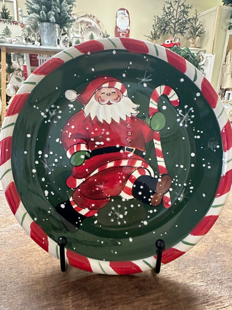 Decorative Christmas plate with dancing Santa in green, red, and white