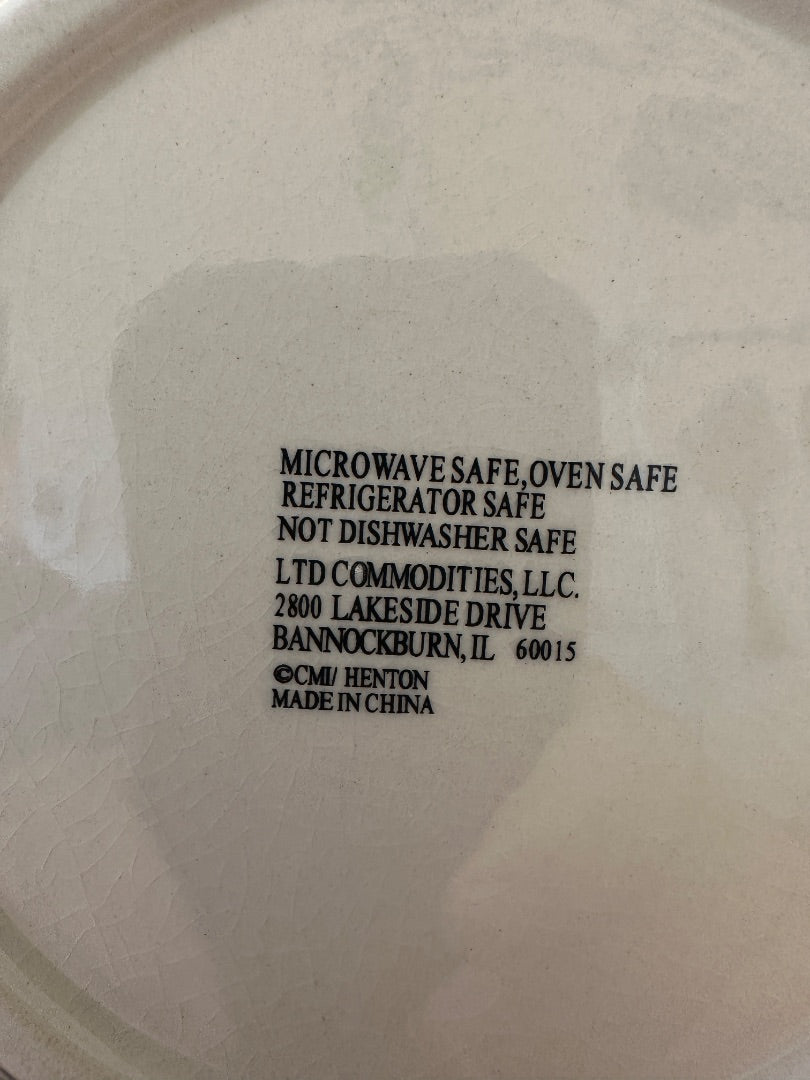 Back of snowman plate close-up showing microwave- and oven-safe care instructions