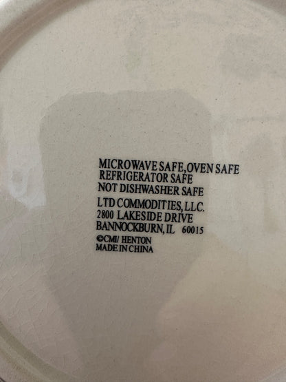 Back of snowman plate close-up showing microwave- and oven-safe care instructions