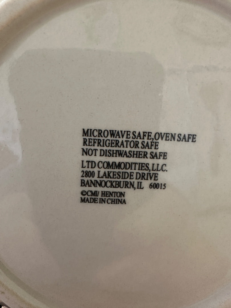 Back of ceramic plate with safety label and LTD Commodities address