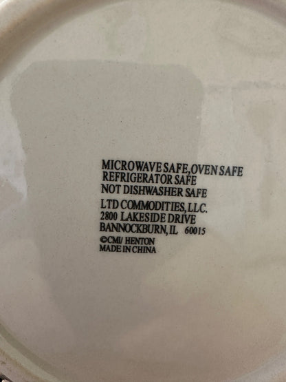 Back of ceramic plate with safety label and LTD Commodities address