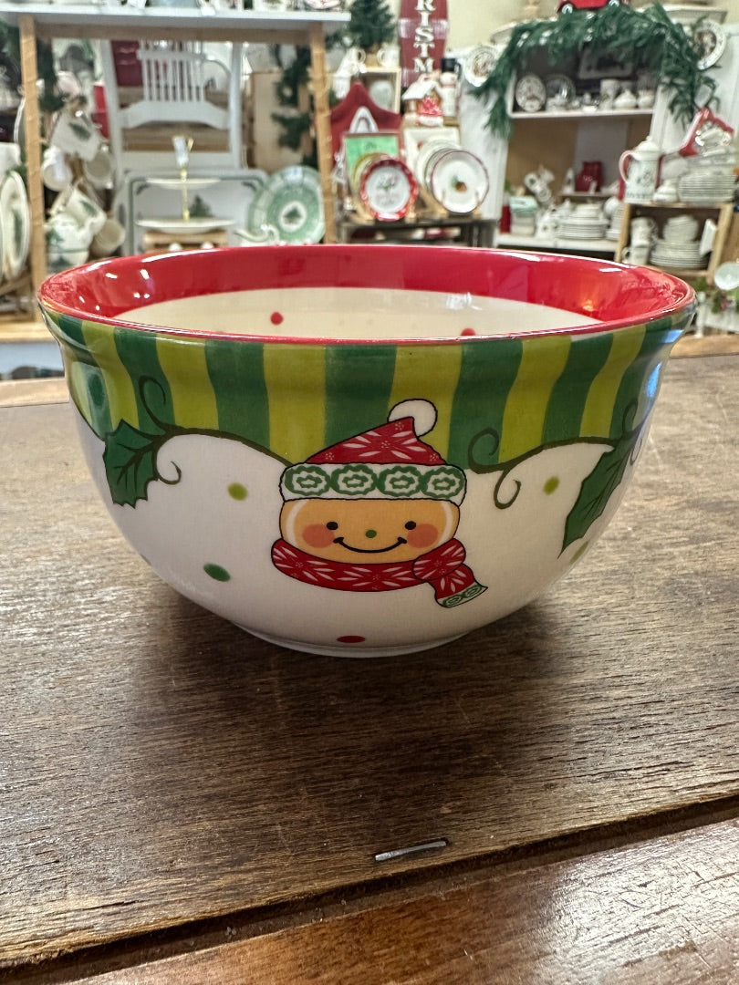 Small ceramic holiday bowl with red rim, green stripes, holly and smiling bear
