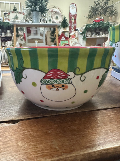 Ceramic serving bowl with green stripes and a smiling snowman face in red accents