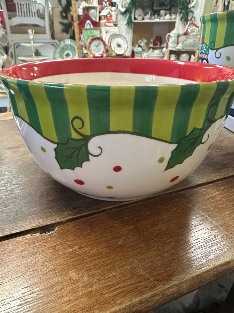 Round ceramic bowl with green striped band, red rim, and holly and snowman graphics