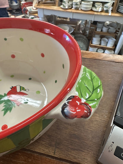 Red-rim ceramic bowl with green leaf side accents and small red heart detail