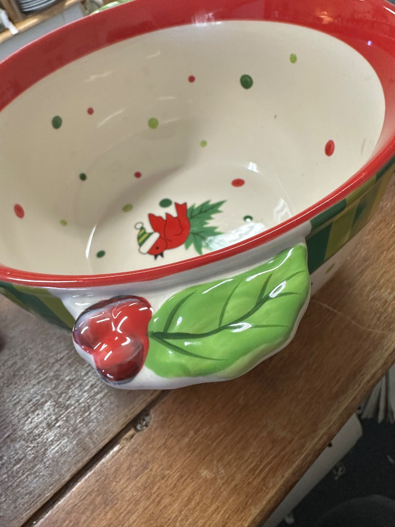 Ceramic winter holiday bowl with red rim, cardinal motif, green leaves, and dots