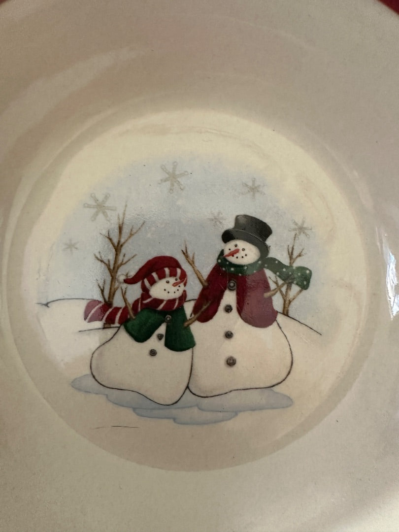 White ceramic bowl with centered snowman and star snowflake design, multicolor