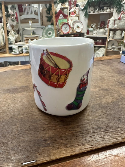 White Christmas mug with drum and penguin prints, red-striped handle