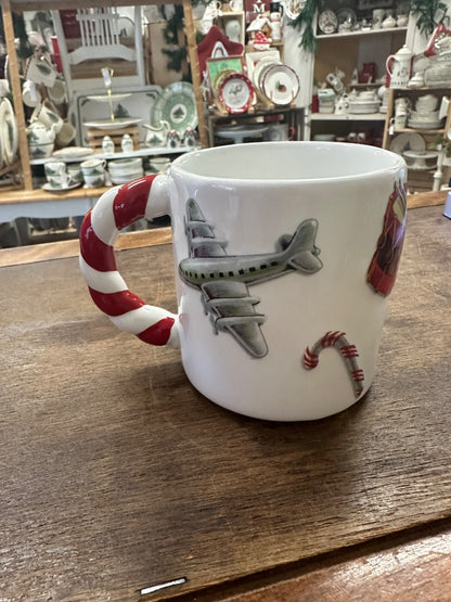 White Christmas mug with airplane print and candy-cane handle