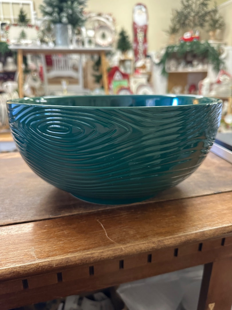 Teal serving bowl with carved woodland-style swirl pattern, glossy finish