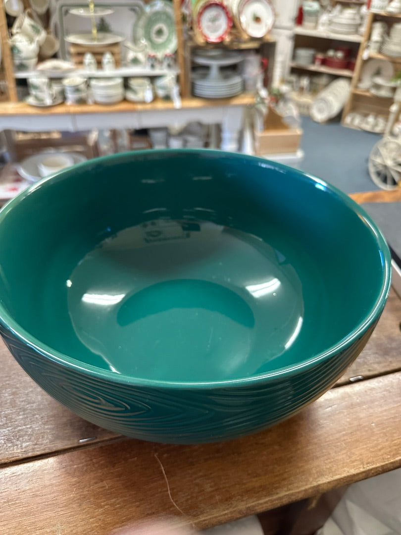Teal ceramic serving bowl with glossy interior and centered swirl texture