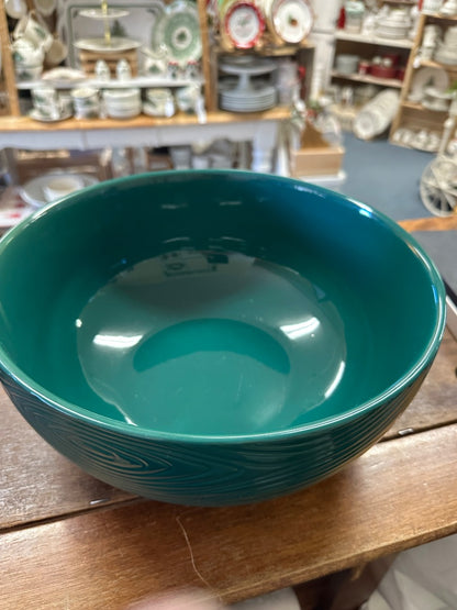 Teal ceramic serving bowl with glossy interior and centered swirl texture