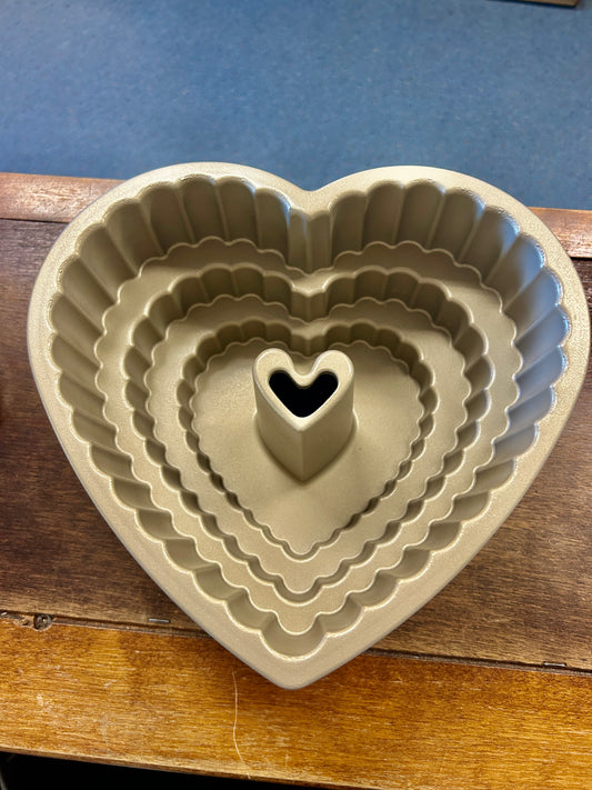 Heart-shaped bundt pan with scalloped ridges and heart-shaped centerpiece cavity