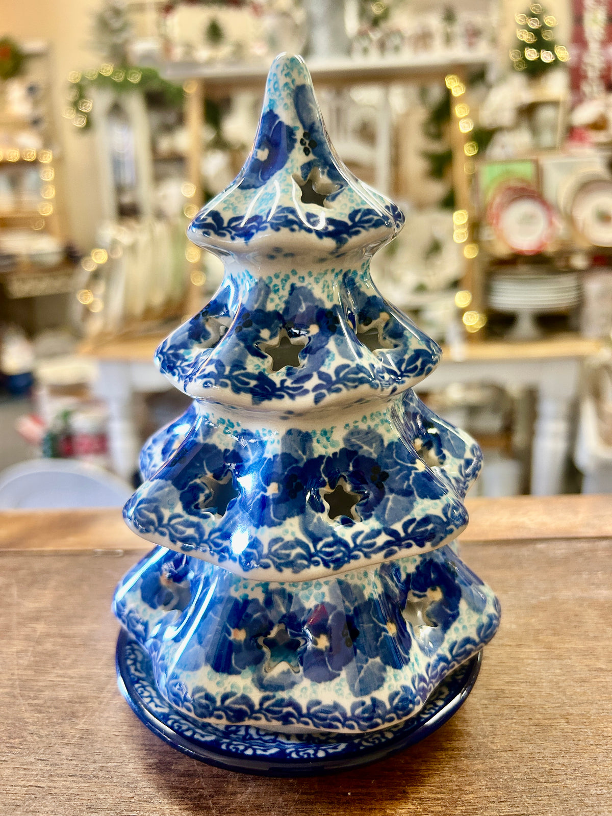 Blue ceramic tree luminary with cutout branches and glossy patterned glaze