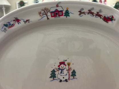 Ceramic oval platter with snowman in center and colorful horse, house, and tree border