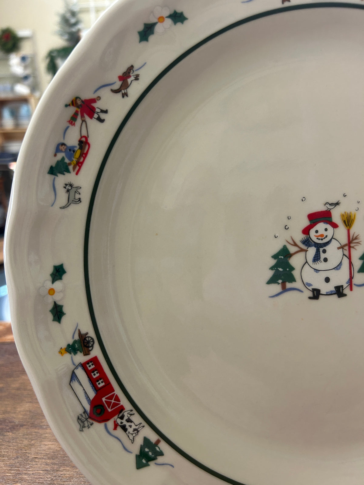 11-inch dinner plate side view with snowman graphic and dark green/red rim border