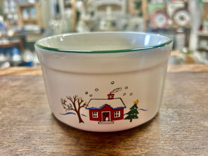 Snow village ceramic bowl with red house, tree, and snow motif, green rim