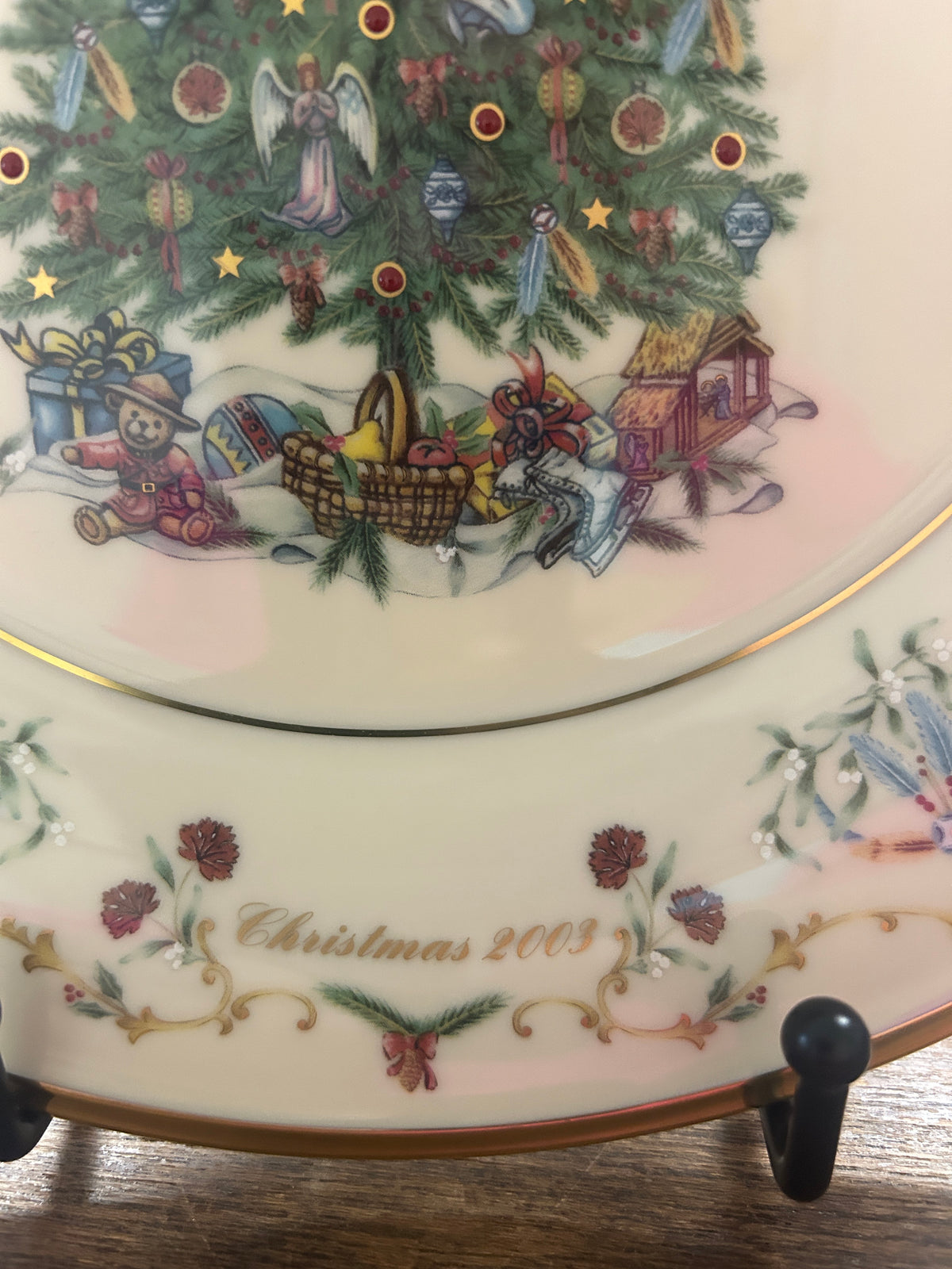 Christmas plate edge showing “Christmas 2003” text with illustrated holiday village scene