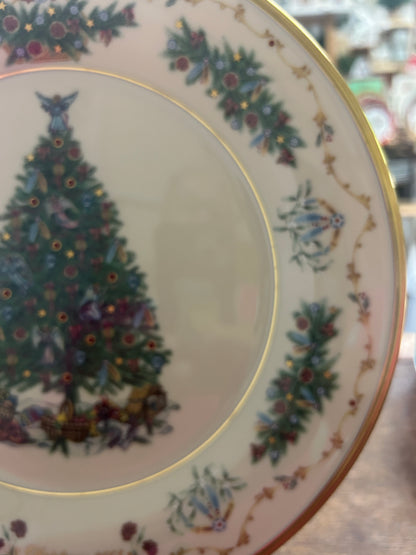 Christmas plate detail: painted tree, blue wreath motifs, and gold rim along the border